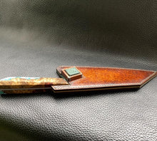 Load image into Gallery viewer, Hand dyed sunburst tan to brown Veg Tanned Leather outer with blue inserts and unique magnet securing mechanism. Fully handmade leather knife sheath which is completely hand stitched and hand finished to ensure the knife within is protected from the elements. We can design to our customer specifications to ensure you get a truly unique and bespoke item.www.leathercompositions.com