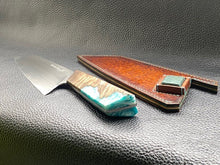 Load image into Gallery viewer, Hand dyed sunburst tan to brown Veg Tanned Leather outer with blue inserts and unique magnet securing mechanism. Fully handmade leather knife sheath which is completely hand stitched and hand finished to ensure the knife within is protected from the elements. We can design to our customer specifications to ensure you get a truly unique and bespoke item.www.leathercompositions.com