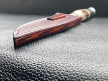 Load image into Gallery viewer, Full English bridle leather with unique welt made from multiple layers of leather to give a unique look. Handmade leather knife sheath which is fully hand stitched and hand finished to ensure the knife within is protected from the elements. We can design to our customer specifications to ensure you get a truly unique and bespoke item. www.leathercompositions.com