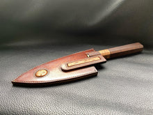 Load image into Gallery viewer, Hand dyed sunburst tan to brown Leather outer with Ostrich skin inlays and blue layers with a unique magnet securing mechanism. Fully handmade leather knife sheath which is completely hand stitched and hand finished to ensure the knife within is protected from the elements. We can design to our customer specifications to ensure you get a truly unique and bespoke item.www.leathercompositions.com