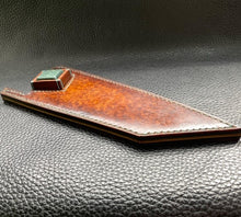 Load image into Gallery viewer, Hand dyed sunburst tan to brown Veg Tanned Leather outer with blue inserts and unique magnet securing mechanism. Fully handmade leather knife sheath which is completely hand stitched and hand finished to ensure the knife within is protected from the elements. We can design to our customer specifications to ensure you get a truly unique and bespoke item.www.leathercompositions.com
