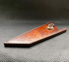 Load image into Gallery viewer, Hand dyed sunburst tan to brown Veg Tanned Leather outer with blue inserts and unique magnet securing mechanism. Fully handmade leather knife sheath which is completely hand stitched and hand finished to ensure the knife within is protected from the elements. We can design to our customer specifications to ensure you get a truly unique and bespoke item.www.leathercompositions.com
