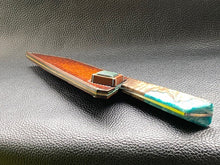 Load image into Gallery viewer, Hand dyed sunburst tan to brown Veg Tanned Leather outer with blue inserts and unique magnet securing mechanism. Fully handmade leather knife sheath which is completely hand stitched and hand finished to ensure the knife within is protected from the elements. We can design to our customer specifications to ensure you get a truly unique and bespoke item.www.leathercompositions.com

