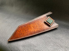 Load image into Gallery viewer, Hand dyed sunburst tan to brown Veg Tanned Leather outer with blue inserts and unique magnet securing mechanism. Fully handmade leather knife sheath which is completely hand stitched and hand finished to ensure the knife within is protected from the elements. We can design to our customer specifications to ensure you get a truly unique and bespoke item.www.leathercompositions.com
